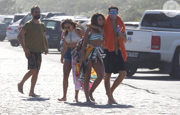 Cauã Reymond e Mariana Goldfarb deixaram a praia abraçados