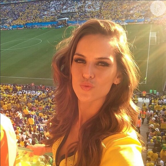 Izabel Goulart posou para uma foto com a torcida do Brasil ao fundo