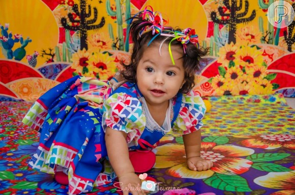 Filha de Juliana Alves, Yolanda usou um vestido com estampa de bandeirinhas e fitas coloridas no cabelo