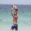 Thiago Lacerda carrega Gael, de 5 anos, no colo e brinca com o filho no mar