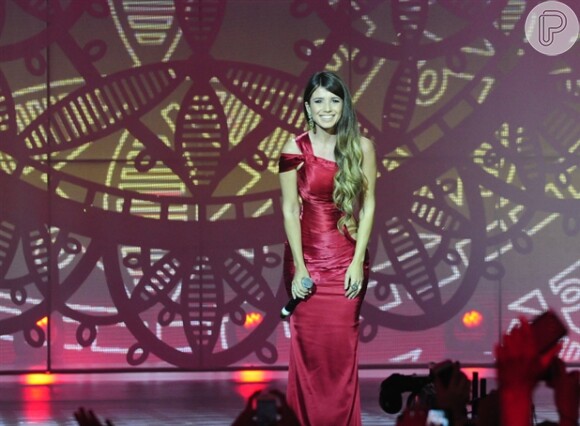 Paula Fernandes com look vermelho durante apresentação