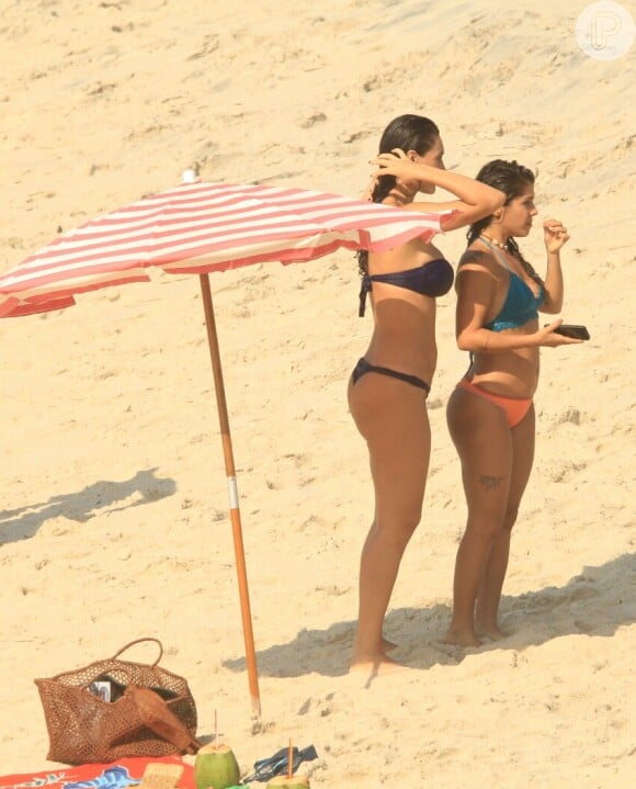 Na praia, Débora Nascimento exibe o corpo enxuto em cenas da novela 'Verão 90' com a colega de elenco Maria Carol