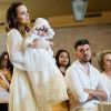Thaeme Mariôto com a filha, Liz, no colo durante batizado