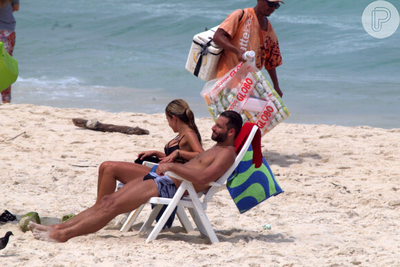 Henri Castelli se exercita com a namorada e mostra boa forma em mergulho na praia da Barra da Tijuca, no Rio