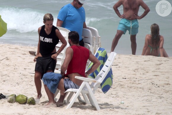 Henri Castelli se exercita com a namorada e mostra boa forma em mergulho na praia da Barra da Tijuca, no Rio