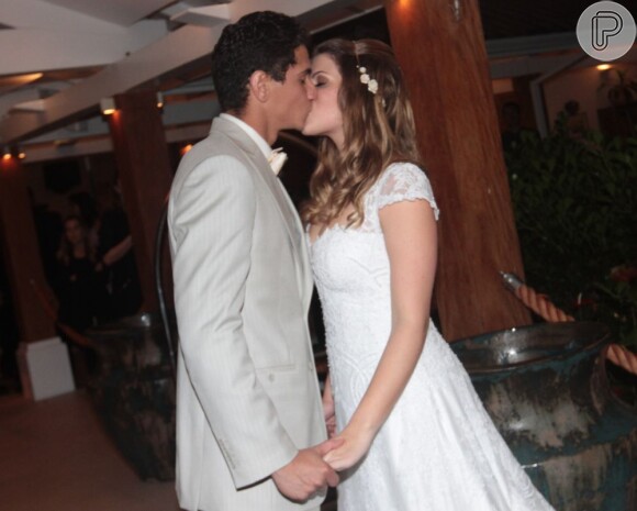 Os noivos posam para uma foto de beijo após oficializar a união