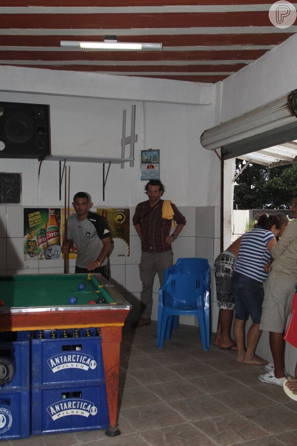 Bradley Cooper visita um bar da comunidade Santa Marta