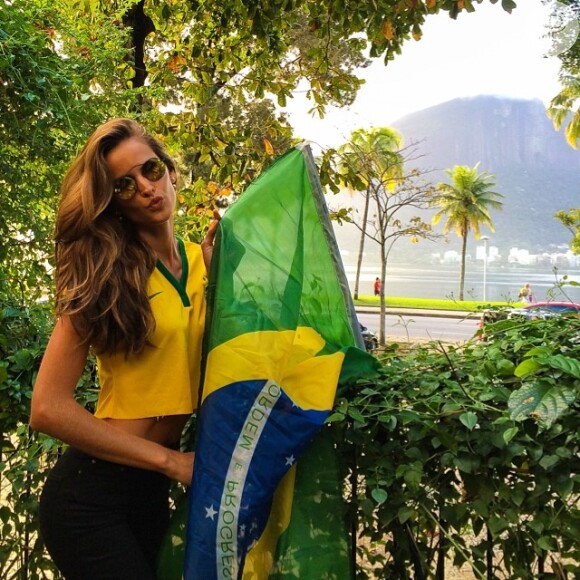 A top brasileira Izabel Goulart posou para foto segurando a bandeira do país. 'Vai Brasil! Ouse ser brasileiro! Arrisque tudo', escreveu na legenda