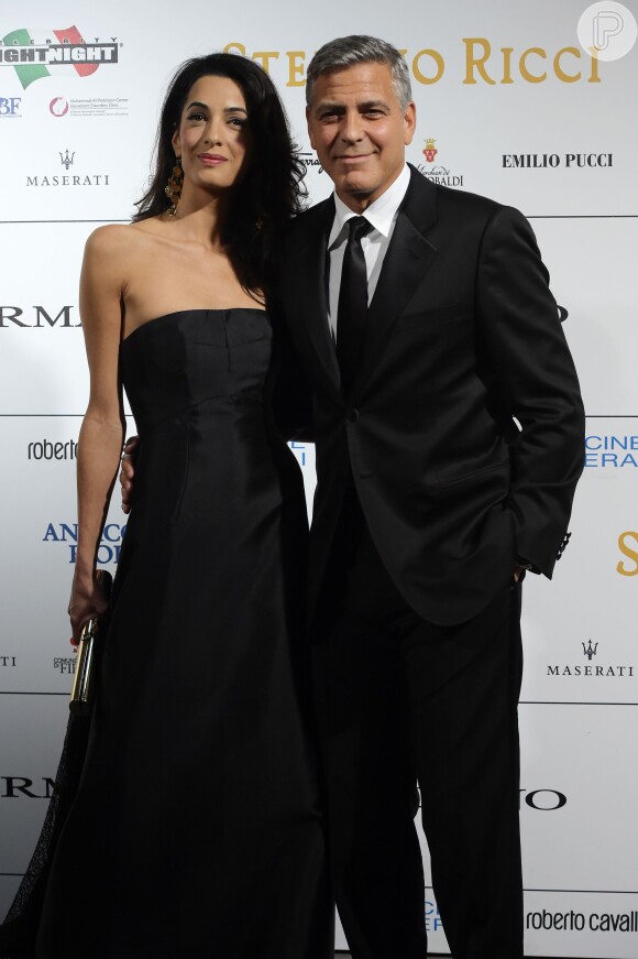 US actor-director George Clooney arrives with his fiancee, British-Lebanese human rights lawyer Amal Alamuddin for the Celebrity Fight Night at the Palazzo Vecchio in Florence, Italy, September 7, 2014. The charity event benefits the Andrea Bocelli Foundation and the Muhammad Ali Parkinson Center. Photo by Eric Vandeville/ABACAPRESS.COM08/09/2014 - Florence