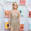 Carrie Underwood elegeu um vestido bordado com transparência na saia e no colo, de Davidson Zaninepara, cruzar o tapete vermelho do Country Music Awards em abril de 2016