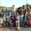 Luciano Huck posta foto dos filhos praticando futebol com as crianças da África