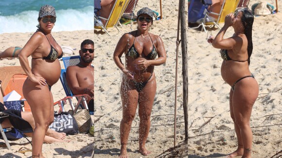 Viviane Araujo exibe barriga de grávida e se refresca em chuveirão em praia no Rio. Fotos!