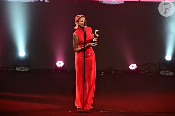 A cantora Ludmilla marcou presença usando um vestido vermelho justo, sem mangas, com uma fenda lateral em uma das pernas.