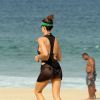 Fernanda Lima usa saída de praia transparente para  correr de biquíni no Rio
