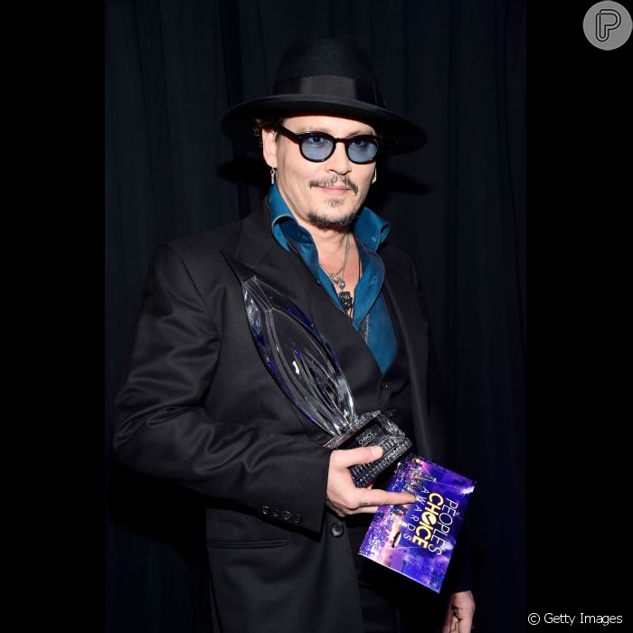  Johnny Depp foi sozinho receber seu prêmio de Melhor Ator em Filme de Drama no People&#039;s Choice Awards 2016. O ator mostrou estilo com óculos de lente azul e chapéu 