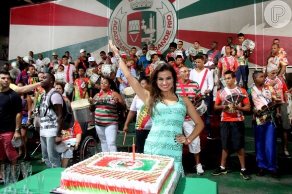 Laryssa posa atrás do bolo e com os integrantes da escola que será destaque no Carnaval 2013
