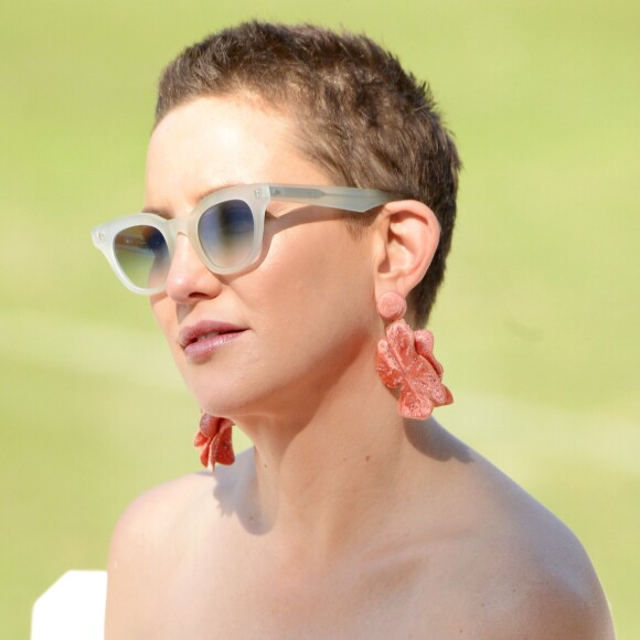 Kate Hudson completou o look fresh com óculos escuros esverdeados e brincos de flores