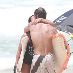 Dani Suzuki e o namorado, Fernando Roncato, trocaram beijos após surfarem na praia da Barra da Tijuca
