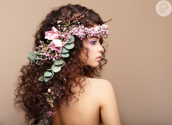 A tiara de flores deixa o penteado semi-preso cacheado ainda mais delicado para as noivas