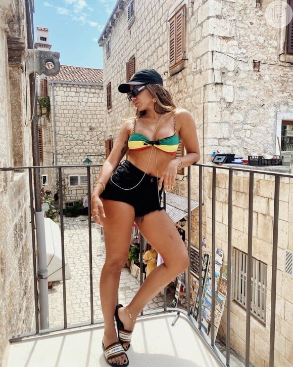 Anitta usa biquíni reggae e microshort em viagem