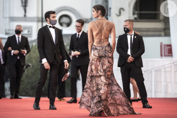A modelo Taylor Hill exibe vestido com recortes e decote generoso nas costas em look do Festival de Cinema de Veneza 2020