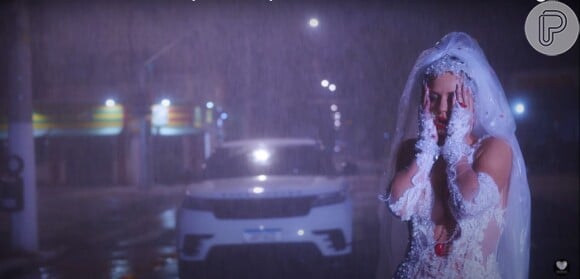 Deolane Bezerra apareceu vestida de noiva e embaixo de chuva no clipe, mas web apontou que cena foi 'macabra'