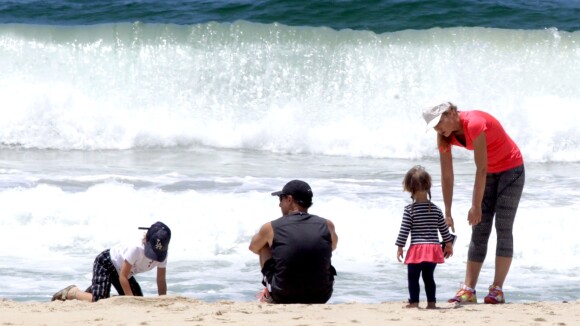 Angélica e Luciano Huck brincam com os filhos Benício e Eva, em praia do Rio