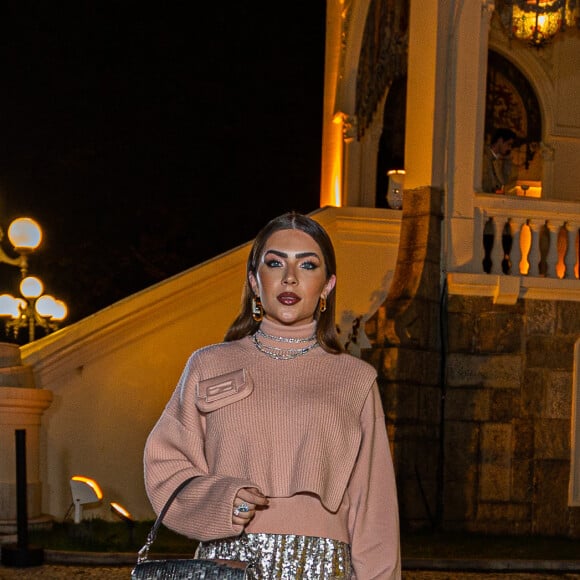 Look de Jade Picon tem saia com brilho e casaco criativo e exótico com minibolsa acoplada