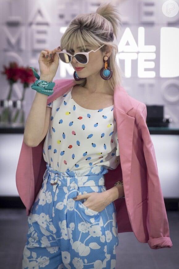 Lu (Julianne Trevisol) usa óculos descolados da grife Fendi, que podem ser encontrados na loja online Farfetch por R$ 1.129 e brincos exclusivos Gla Acessórios, indisponíveis para venda, no valor de R$ 168. A  blusa com estampa de picolés é da marca Isolda e custa de R$ 1.300
