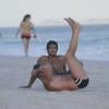 Marcello Novaes é observado pelo filho, Diogo, enquanto faz uma sequência de abdominais na areia da praia da Barra da Tijuca, Zona Oeste do Rio de Janeiro