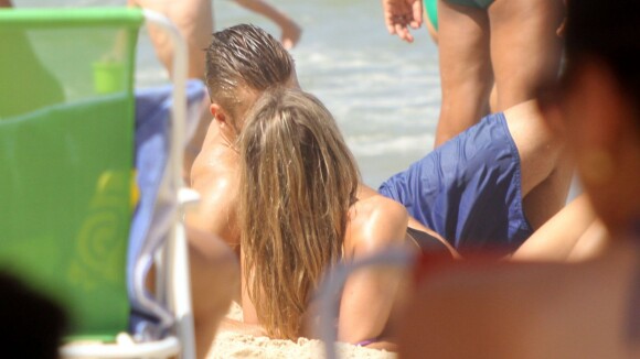 Fernanda Lima deita na areia e namora Rodrigo Hilbert em praia do Rio de Janeiro