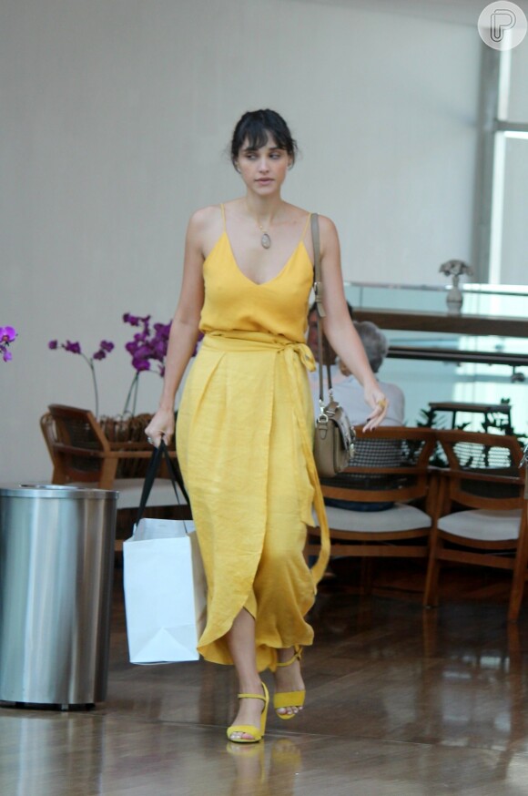 Débora Nascimento usou vestido amarelo mostarda e sandálias de santo bloco do mesmo tom, em combinação elegante