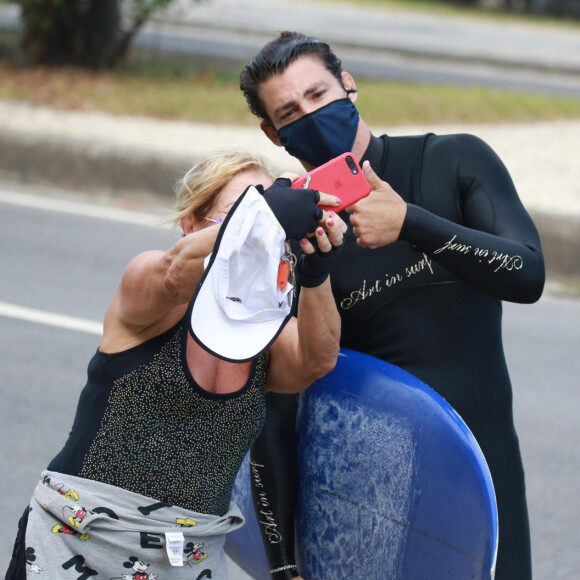 Cauã Reymond é abordado por fã e posa para selfie na praia

