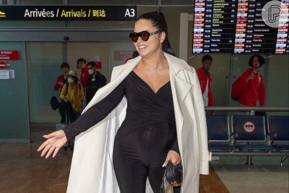 A modelo Adriana Lima chegou em Cannes com um macacão preto ajustado ao corpo