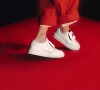 Tênis Nike branco pode compor look monocromático vermelho com estilo