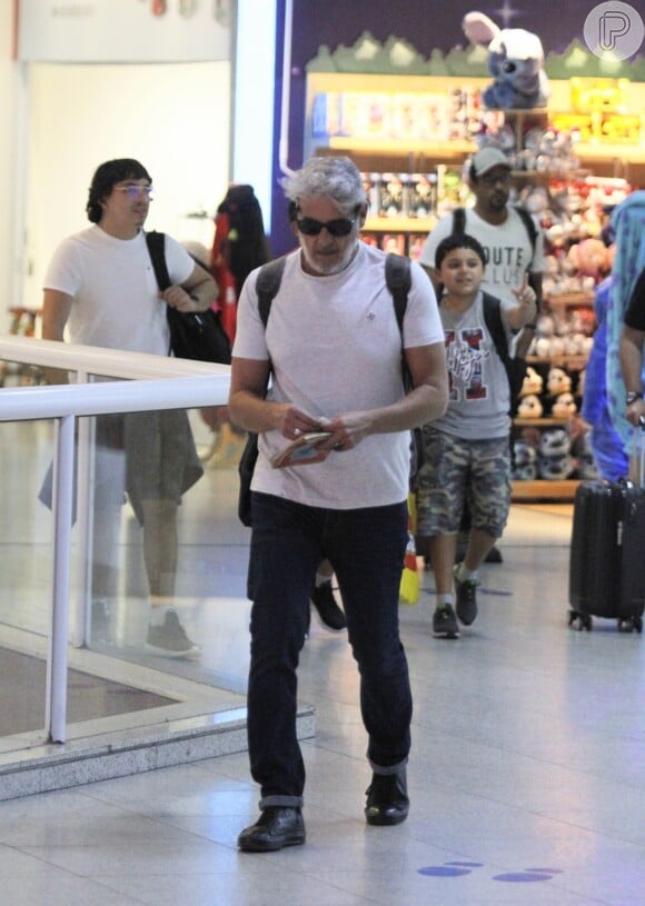 Ator Alexandre Borges estava usando um look simples para viajar: Camiseta branca, jeans e sapatos pretos.