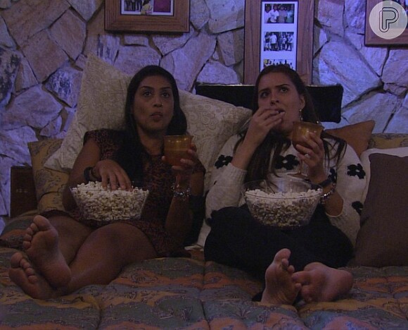 Tamires e Amanda assistem a filme sentadas no chão