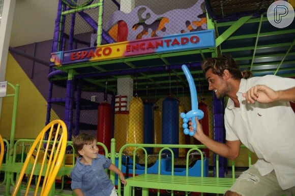Felipe Simas e o filho, Joaquim, brincam no salão de festas