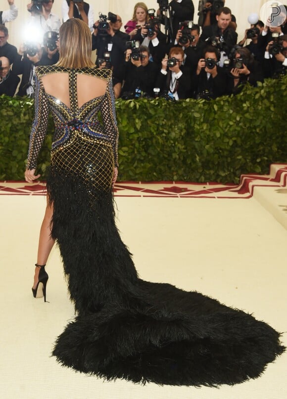 Vestido usado por Jennifer Lopez possui cauda de plumas, fenda e detalhes bordados em formato de cruz no colo