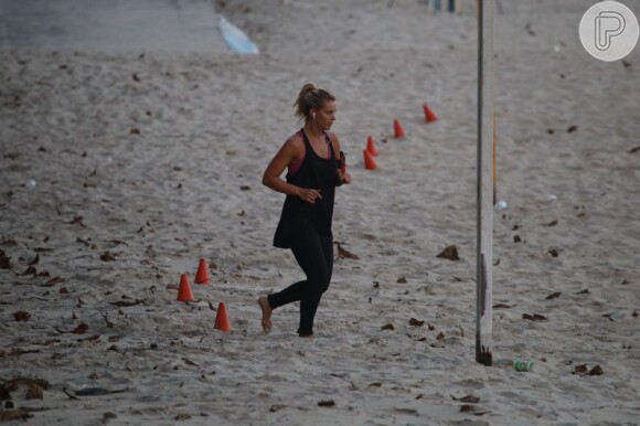 Carolina Dieckmann suou a camisa durante as atividades de circuito na praia