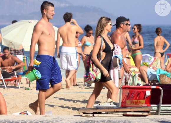 Casal de apresentadores passeia pela areias do Leblon em dia de sol. Os termômetros marcaram 33ºC no Rio