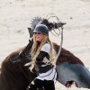 Avril Lavigne has some fun on day two of filming with a saw blade electric guitar on the set of Rock N Roll in Palmdale, Los Angeles, CA, USA on July 26, 2013. The sexy blond rocker chased around what appeared to be a bear shark with a mad max style guitar with a saw blade on it. She laughed as she charged the man in costume and even fell to the ground as she slipped in the sand. Photo by GSI/ABACAPRESS.COM27/07/2013 - Los Angeles