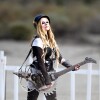 Avril Lavigne has some fun on day two of filming her music video with a saw blade electric guitar on the set of Rock N Roll in Palmdale, Los Angeles, CA, USA on July 26, 2013. The sexy blond rocker chased around what appeared to be a bear shark with a mad max style guitar with a saw blade on it. She laughed as she charged the man in costume and even fell to the ground as she slipped in the sand. Photo by GSI/ABACAPRESS.COM27/07/2013 - Los Angeles