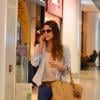 Fernanda Machado não desgruda do celular no aeroporto Santos Dumont