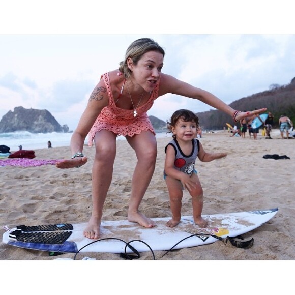 Scooby postou no Instagram uma foto da mulher e filho brincando de surfar. 'Meus amores tirando uma ondinha aqui em Noronha! #EstamosNoParaiso #PuraDiversao', legendou