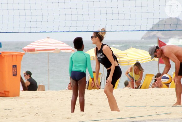 Fernanda Lima deixou o cabelo preso em forma de coque durante jogo de vôlei de praia