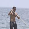 Bruno Gagliasso exibe boa forma ao praticar stand up paddle em praia carioca, em janeiro de 2014