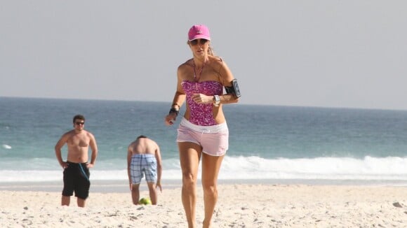 Aos 46 anos, Christine Fernandes exibe boa forma e se exercita em praia do Rio