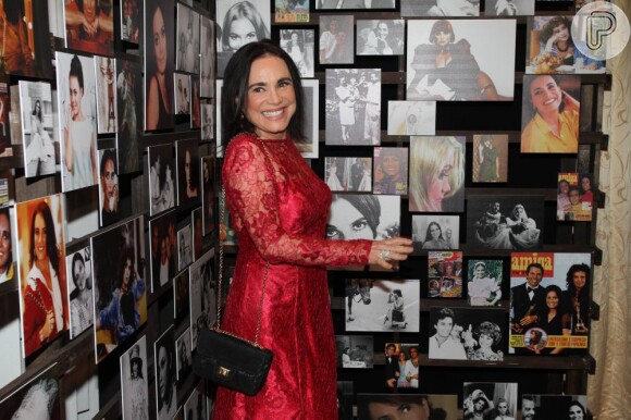 Regina Duarte posa ao lado de suas fotos
