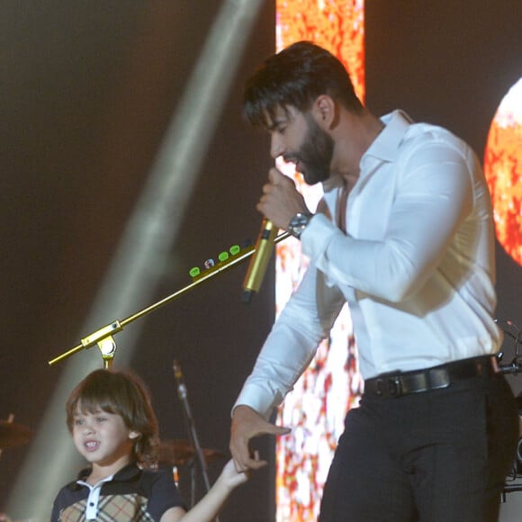 Gusttavo Lima caminha com o filho Samuel em palco